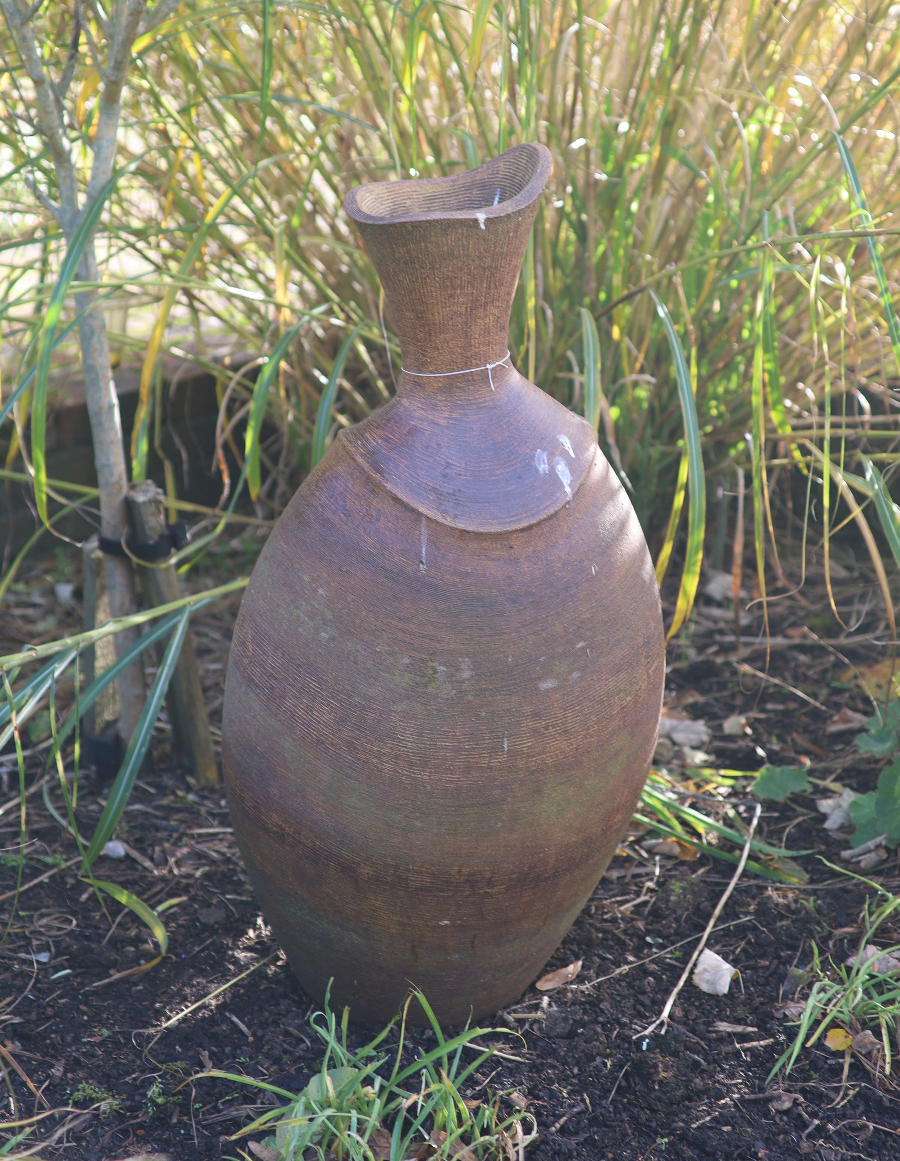 A terracotta garden urn ornament, height 86cm
